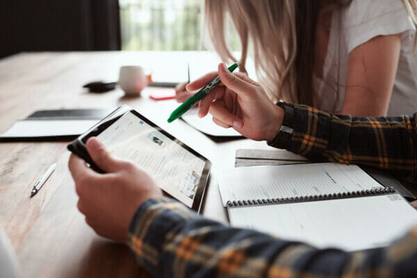 A couple looking at finances together on an iPad.